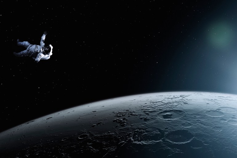 Astronaut floating in space - stock photo