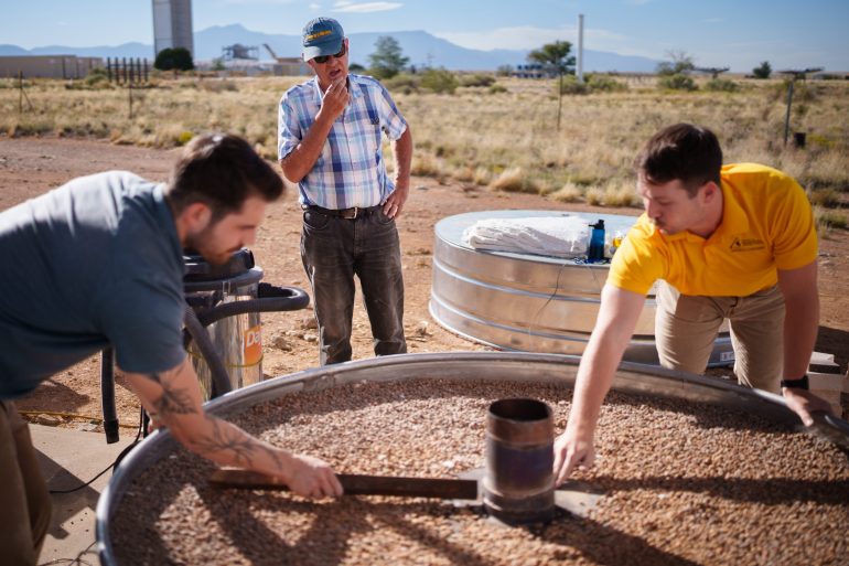 Sandia National Laboratories mechanical engineers Nathan Schroeder, left, and Luke McLaughlin, right, discuss the design of a thermal energy storage system with CSolPower co-founder Walter Gerstle, center. Sandia is testing CSolPower’s thermal energy storage system at the National Solar Thermal Test Facility. (Photo by Craig Fritz)