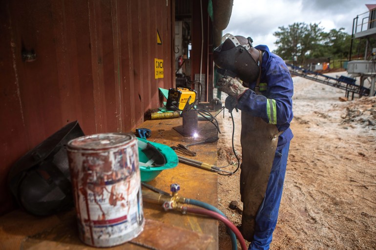 A welder works on some stills before heading into the warehouse for repairs at Arcadia lithium mine [File: Tafadzwa Ufumeli/Getty Images]