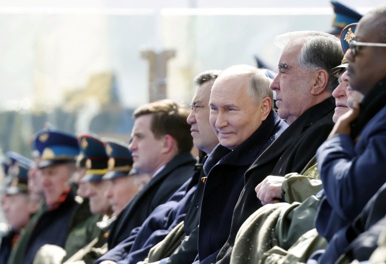 Spectators and officials, including Russian President Vladimir Putin, watch a military parade on Victory Day, which marks the 79th anniversary of the victory over Nazi Germany in World War Two, during a snowfall in Red Square in Moscow, Russia, May 9, 2024. Sputnik/Dmitry Astakhov/Kremlin via REUTERS ATTENTION EDITORS - THIS IMAGE WAS PROVIDED BY A THIRD PARTY.