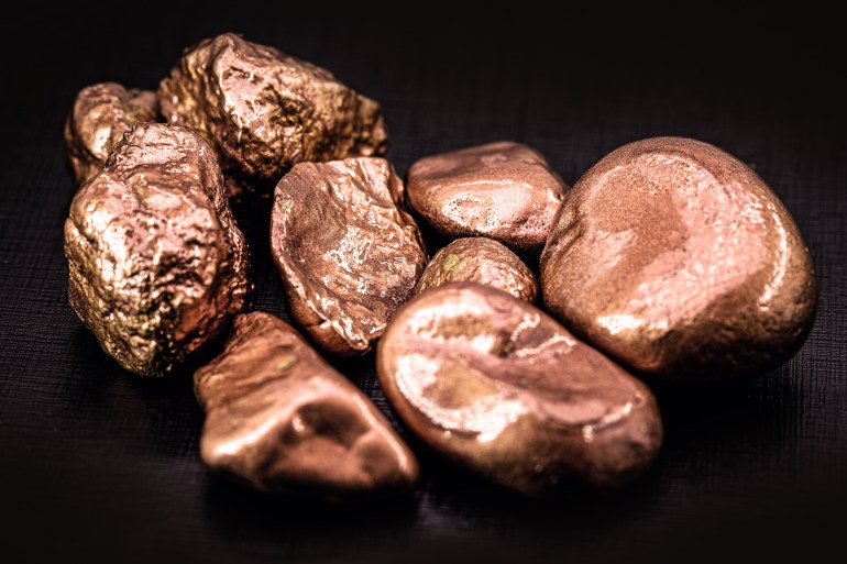 native copper nuggets isolated on black background, ore for industrial use in electrical wires and household utensils