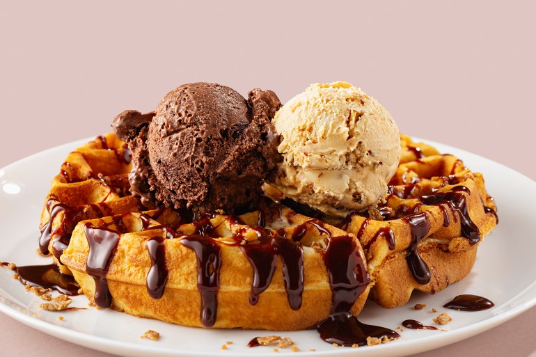 Close-up of waffle with ice cream gelato scoop on plate