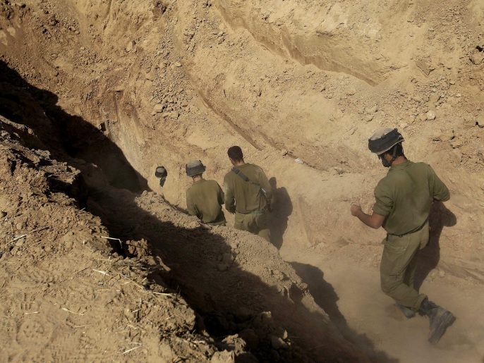 FILE - In this Sunday, Oct. 13, 2013 file photo, Israeli soldiers enter a tunnel discovered near the Israel Gaza border. Israel's military chief Lt. Gen. Gadi Eisenkot said Tuesday, Feb. 9, 2016, that Gaza's Hamas rulers have been rebuilding the sophisticated network of underground tunnels that Israel damaged during the 2014 war. Eisenkot said destroying this network is the military's top priority for 2016. (AP Photo/Tsafrir Abayov)