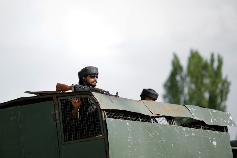An Indian Army soldier looks out from an armoured vehicle on a highway leading to South Kashmir's Pahalgam, following a suspected militant attack, in Marhama village, in Kashmir, April 23, 2025. REUTERS/Adnan Abidi