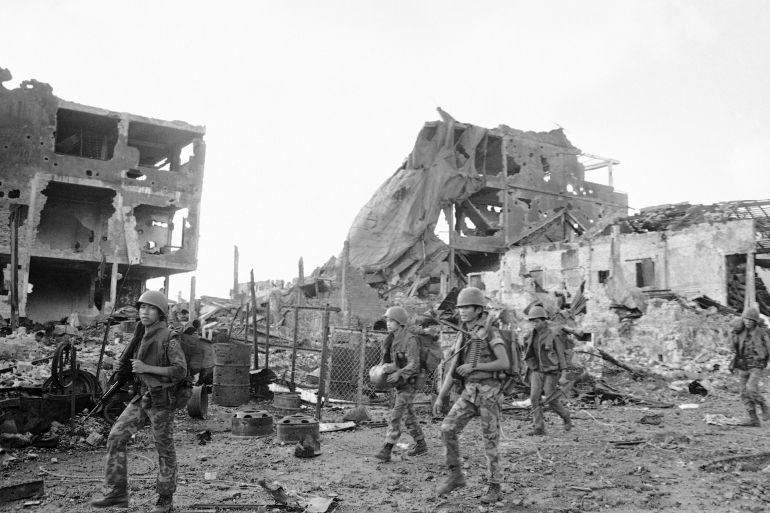 South Vietnamese rangers patrol past destroyed buildings in besieged An Loc, 60 M. No. of Saigon on Thursday, June 15, 1972. Buildings were destroyed by heavy North Vietnamese artillery barrages and allied air strikes over last two months. (AP Photo/Lo Hung)