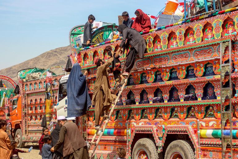 Afghan refugees deported from Pakistan disembark a truck upon their arrival at a makeshift camp near the Afghanistan-Pakistan border in Torkham, Nangarhar province on April 7, 2025. Islamabad announced at the start of March that 800,000 Afghan Citizen Cards (ACC) would be cancelled -- the second phase of a deportation programme which has already forced 800,000 undocumented Afghans across the border. (Photo by AFP)