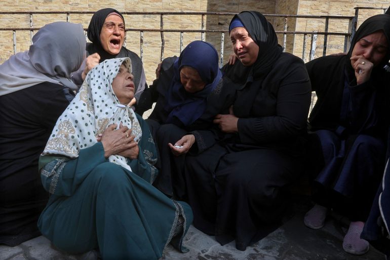 Palestinian women bid farewell to loved ones at Gaza City's Al-Ahli Arab hospital, also known as the Baptist hospital, following an Israeli airstrike that hit an UNRWA school, serving as a shelter for people who left their homes in the besieged Palestinian territory, on May 20, 2025.