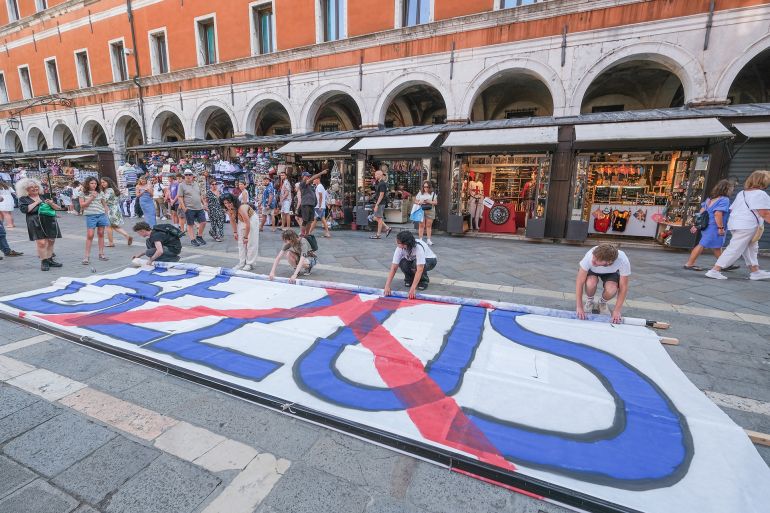 VENICE, ITALY - JUNE 13: "No Space For Bezos" activists gathered in Campo San Giacomo di Rialto to organise protests against the wedding to be held in Venice from 26 to 28 June 2025 on June 13, 2025 in Venice, Italy. Venice is confirmed as the city of choice for the wedding of Amazon Group founder, owner and chairman Jeff Bezos to Lauren Sanchez. (Photo by Stefano Mazzola/Getty Images)