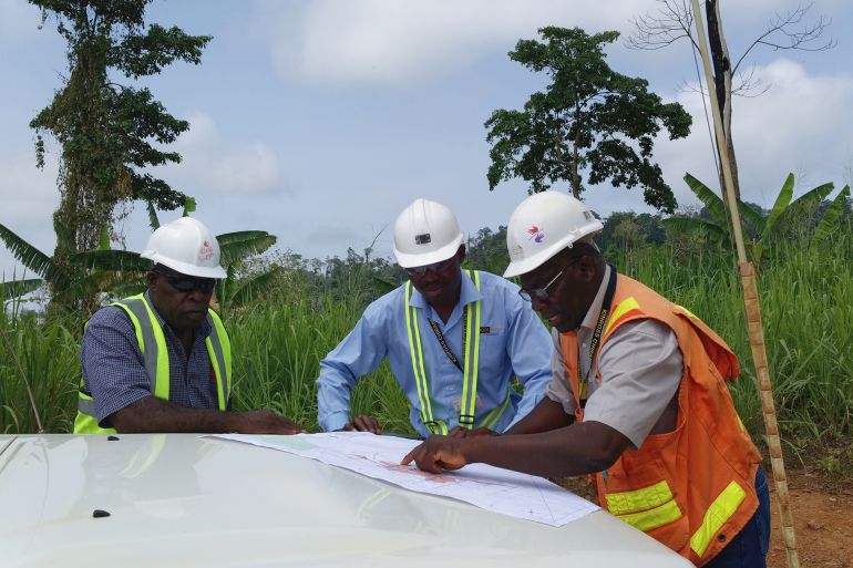 Nsuonsia, Ghana - April 26, 2017: exploration team of a gold mining company on a briefing and having a look at maps on remote exploration permits.