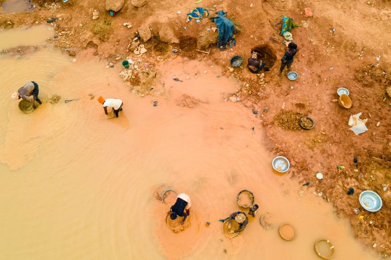 Kunsu, Ghana - March 20th, 2023: Rural Women in Small Scale Mining (Galamsey) in Ghana, Africa. The quest for the daily meal of these women relies on them finding gold in an already mined land.