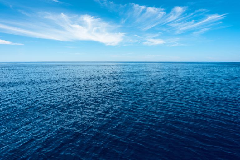 nobody in blue sea with horizon under blue sky in Greece