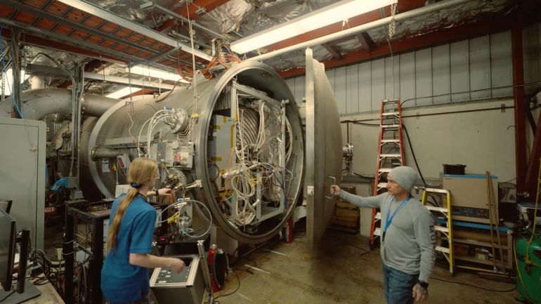 The prototype thruster is enclosed in JPL’s condensable metal propellant (CoMeT) vacuum facility, a unique national asset designed to safely test thrusters using metal-vapor propellants as part of potential megawatt-class electric propulsion systems. Credit: NASA/JPL-Caltech